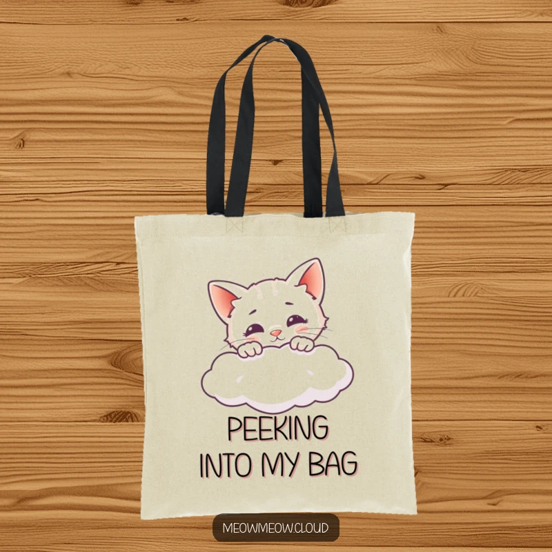 Funny tote bag with a curious cat peeking over a cloud, perfect for carrying everyday items.